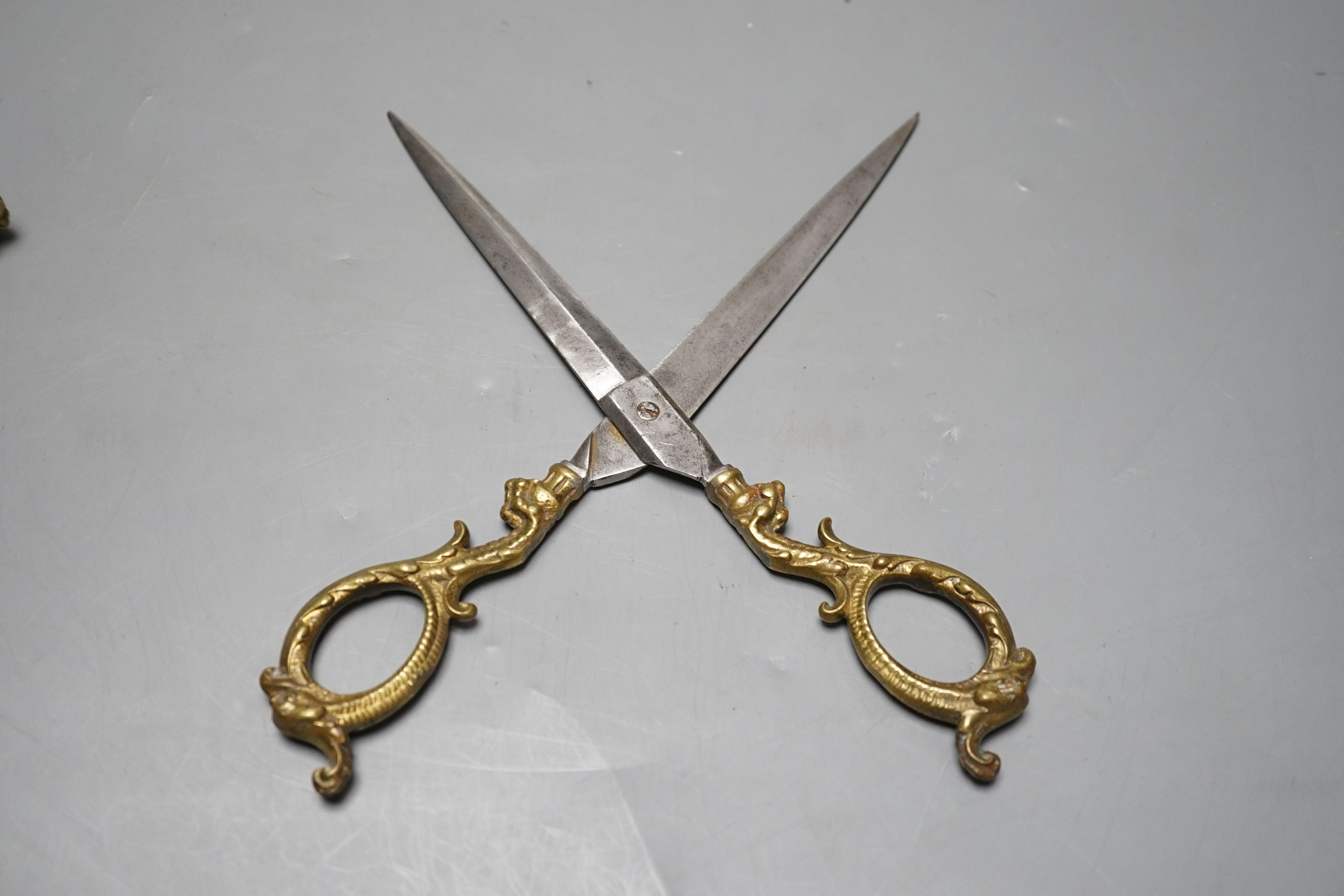 A pair of embossed brass scissors and cover